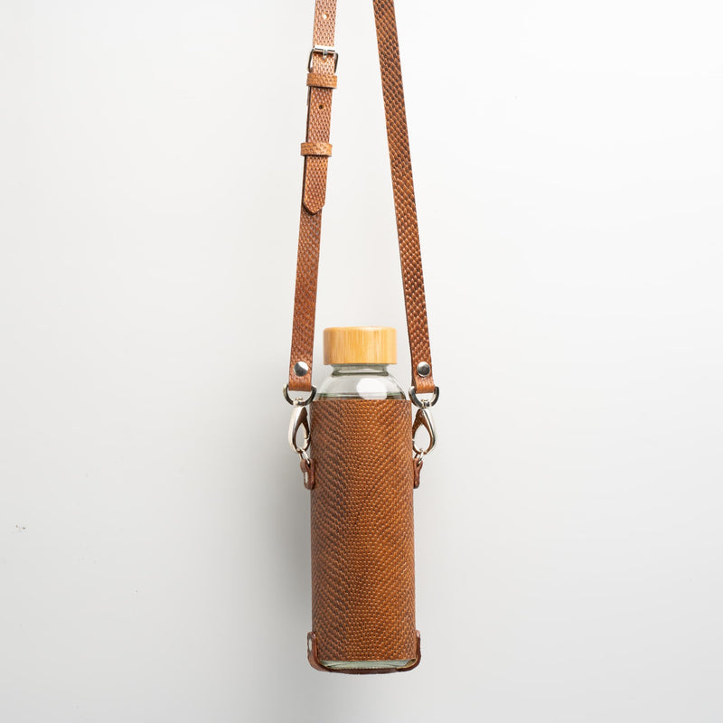 Leather water bottle holder with strap and glass bottle